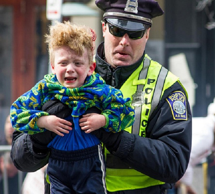 Police in safety vest help lost child back home